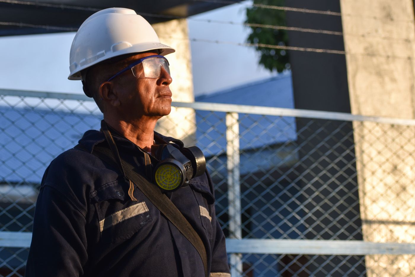 Worker wearing a hard hat and safety glasses at a construction site, illustrating the household protection question behind life insurance vs AD&D.